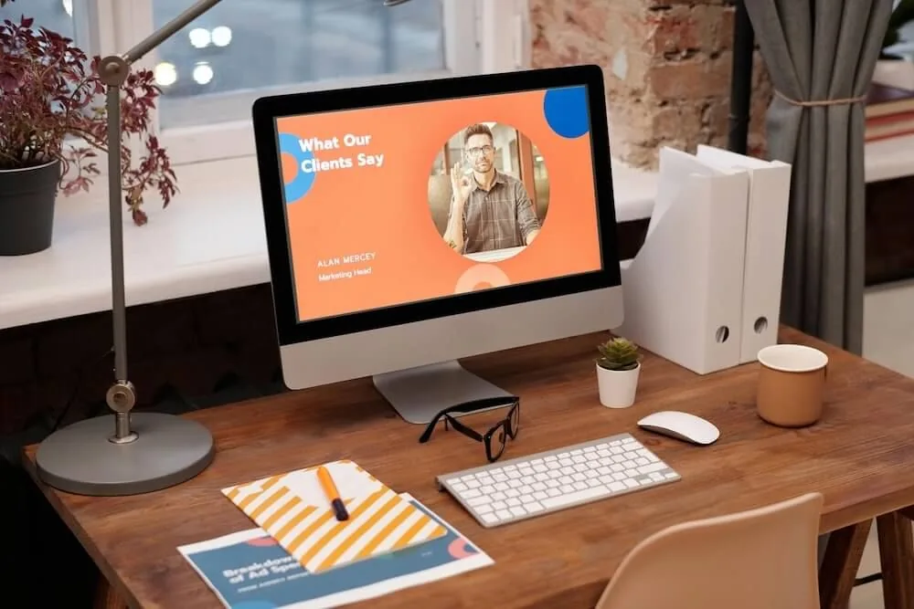 Desktop computer displaying an orange website Home page.